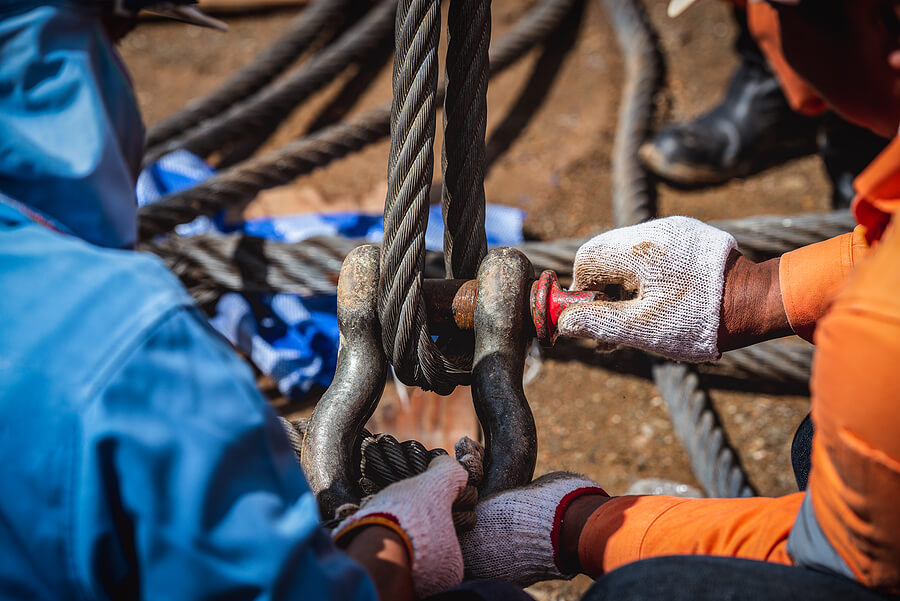 Close up on crane rigger hook being inspected